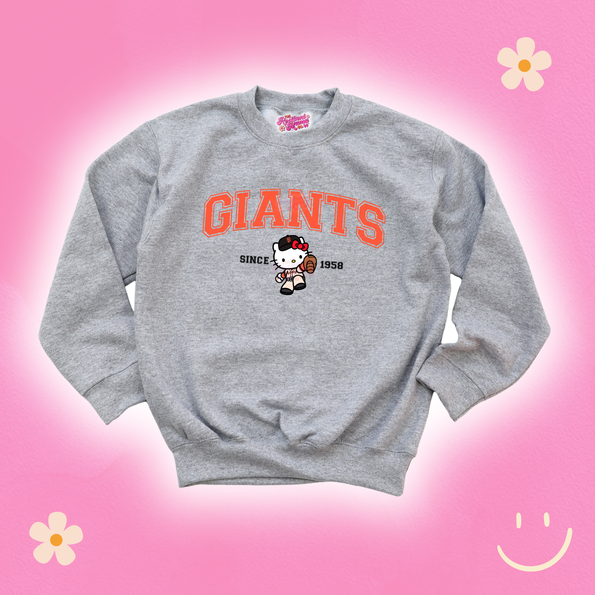 Gray sweatshirt with 'GIANTS' text and cartoon character on a pink background
